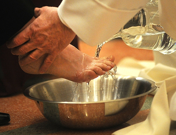 Bishop Richard J. Malone washes the feet of 12 parishioners at St. Joseph Cathedral during the Evening Mass of the Lord's Supper. (Dan Cappellazzo/Staff Photographer)